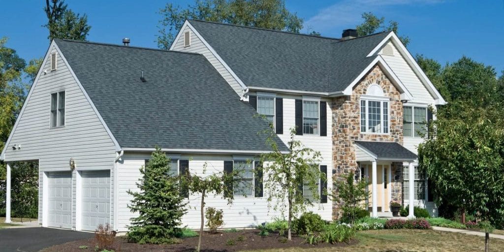 professionally painted levittown home exterior with brick and white siding